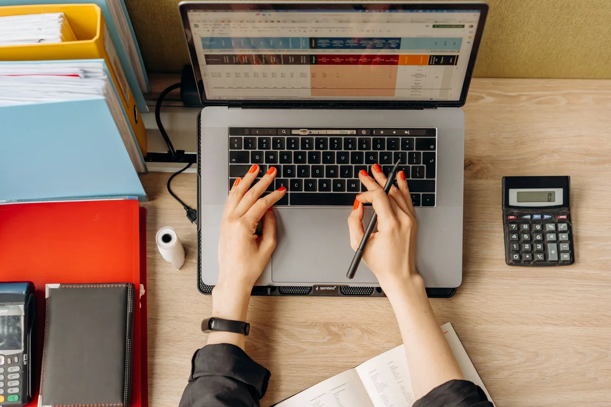 Creator working at a laptop, planning a lead magnet document — starting from a Beacon template rather than a blank page