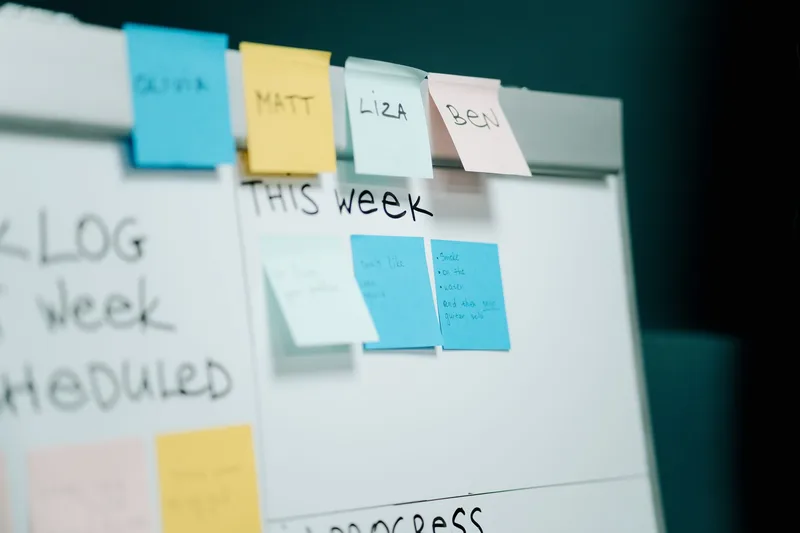Sticky notes laid out to plan the trigger and email steps of an automated workflow