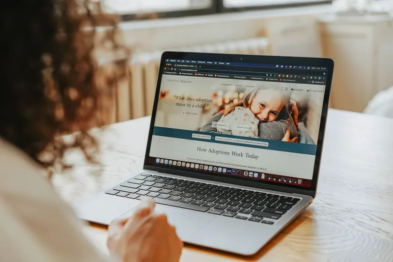 A person reading a blog post on a laptop, highlighting how content upgrades appear inline within articles