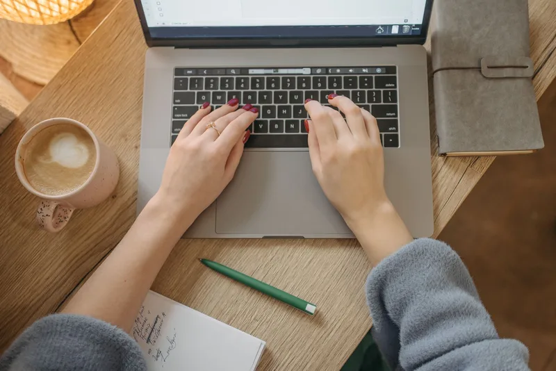 Creator composing a lead magnet delivery email at a laptop in a home office