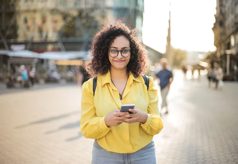A person checking their phone, representing the mobile test of a lead magnet delivery email
