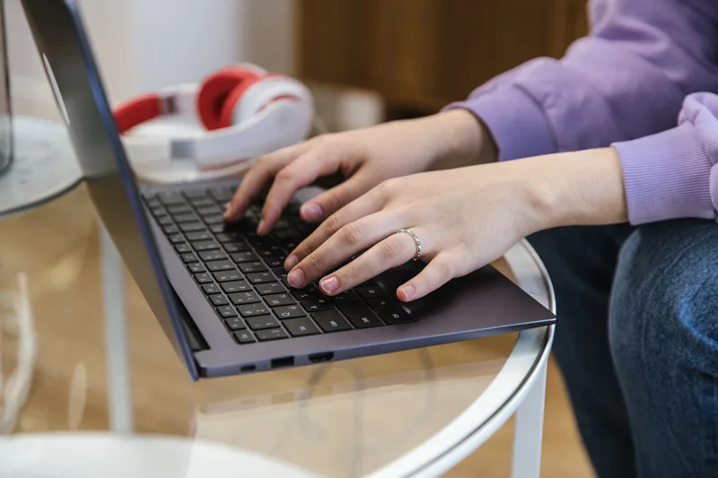 Close-up of a phone and laptop screen showing collected email and message examples