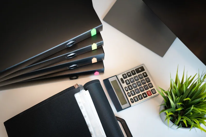 Organized folder of collected writing examples on a desk